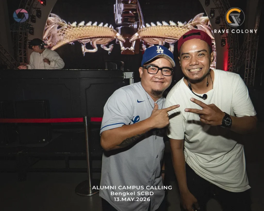 Two men pose for a photo at a nightclub stage during Alumni Campus Calling, Bengkel SCBD, May 13, 2026, flashing peace signs.
