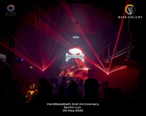 Nightclub scene with red laser beams a silhouetted crowd and a central screen displaying the HardBassBash logo for the SectorLoc event on 09 May 2026