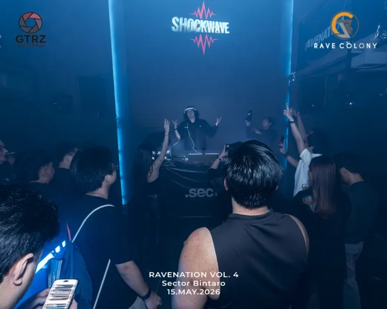 DJ performing on a blue lit stage with a cheering crowd event reads RAVENATION VOL 4 Sector Bintaro 15MAY2026 and logos for GTRZ and RAVE COLONY