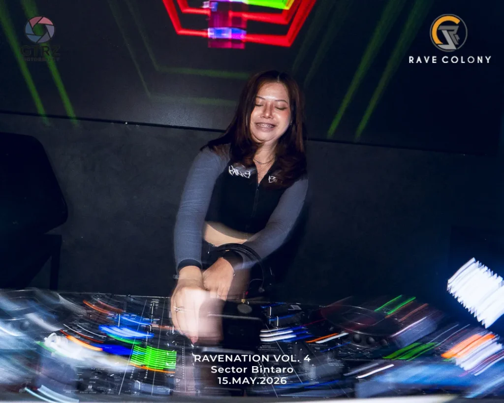 DJ smiling and mixing tracks at a nightclub, colorful lights and club gear visible in the foreground.