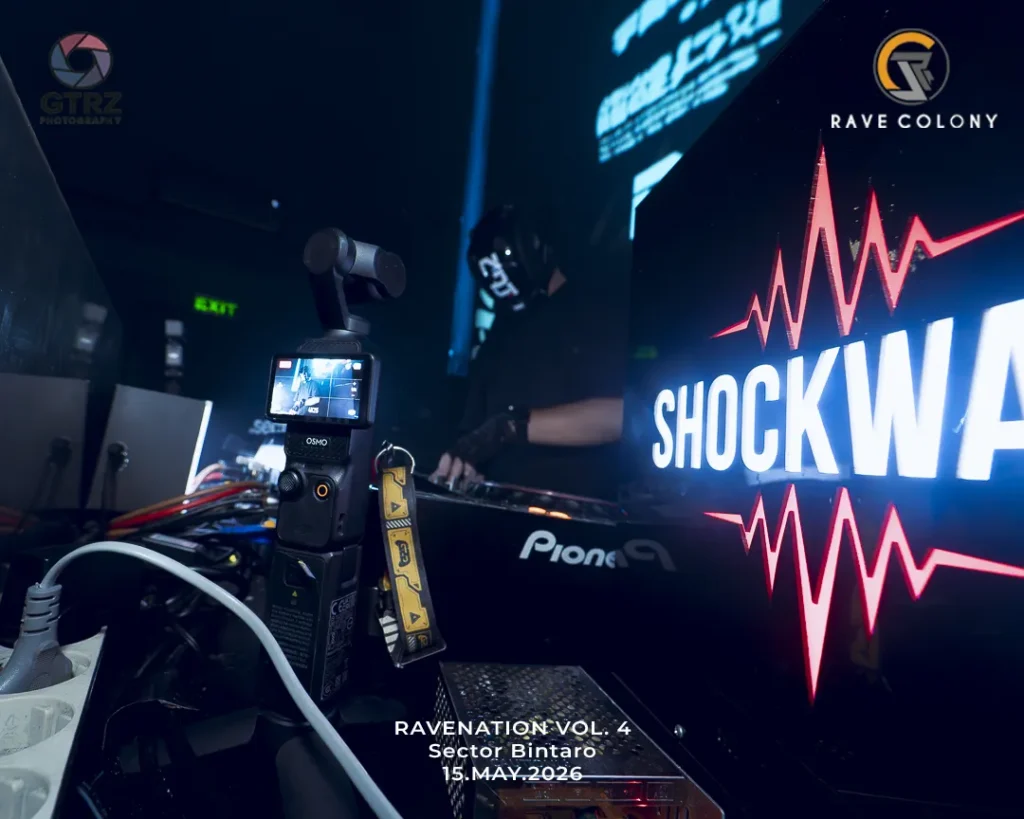 DJ booth with SHOCKWAVE banner and camera gear; event promo text shows Ravenation Vol. 4, May 15, 2026