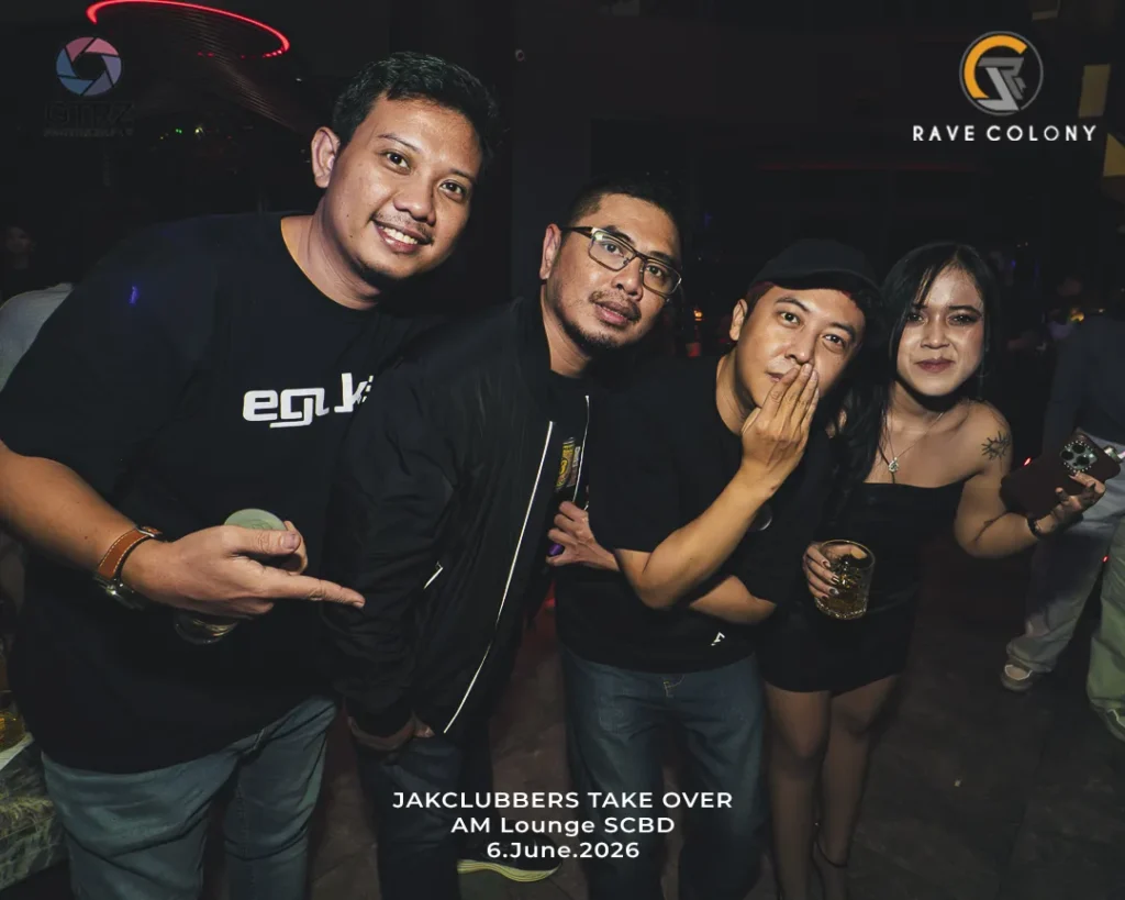 Four friends pose for a photo at a nightclub event, smiling at the camera; two men in black tops, a man in a cap, and a woman in a black dress holding a drink, with event text at the bottom.