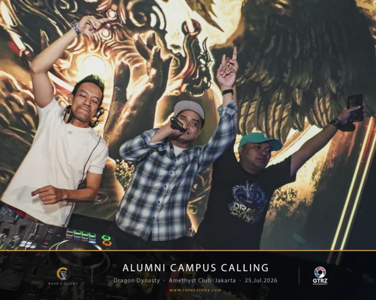 Three DJs perform on stage at the Alumni Campus Calling event, one with a microphone and others with raised arms, against a dragon-themed backdrop.