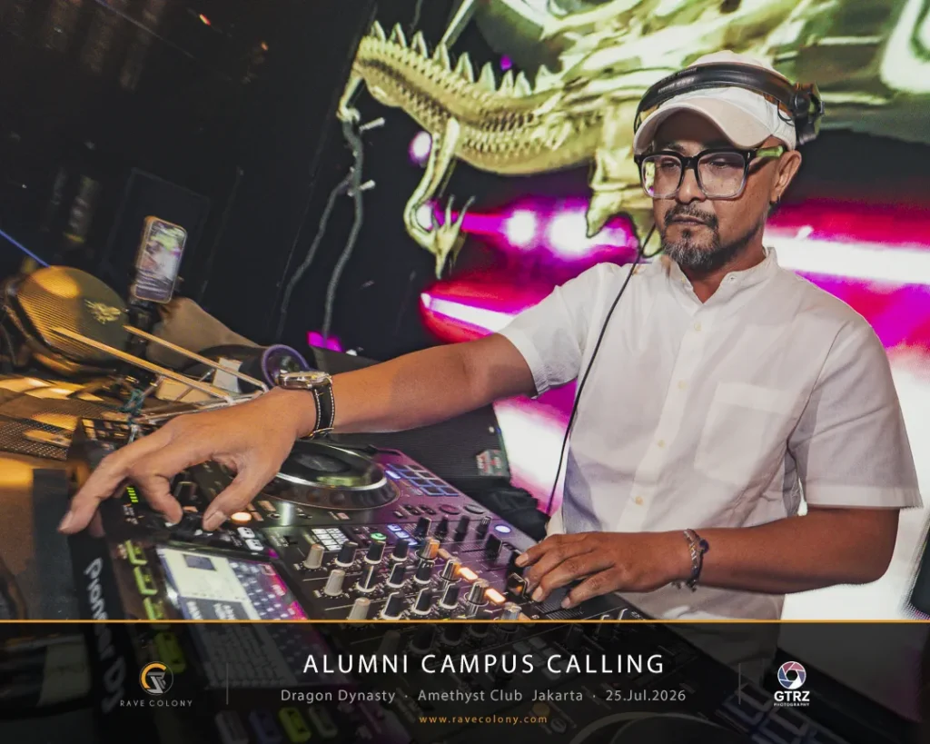 DJ in a white shirt and cap operates a professional mixer at a nightclub, with a dragon mural in the background and event graphics visible on the screen behind him.