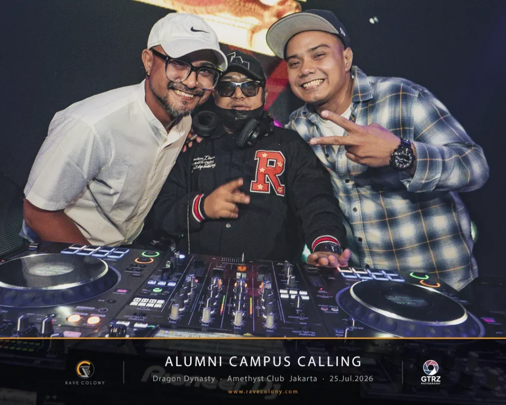 Three men pose at a DJ booth with turntables and mixers during the Alumni Campus Calling event.