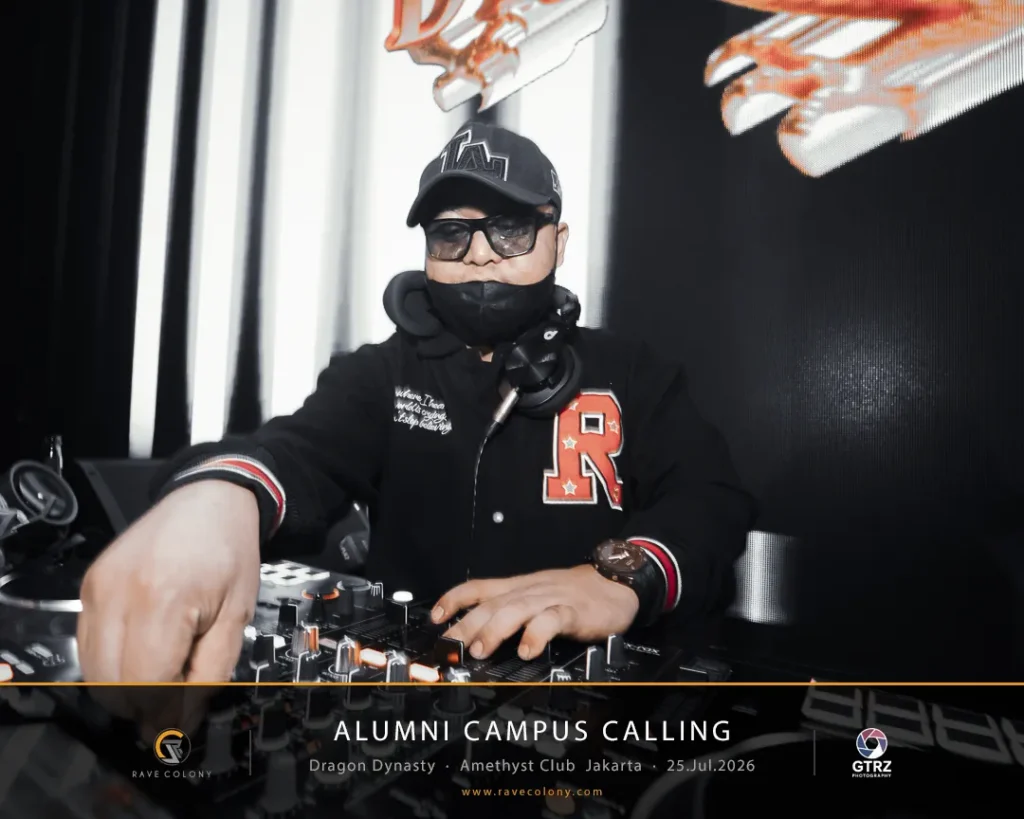 DJ wearing cap and mask, mixing on a club mixer at the Alumni Campus Calling event stage.