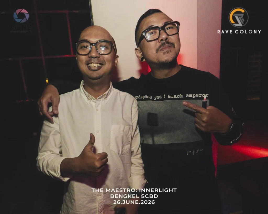 Two men wearing glasses pose with arms around each other at a nighttime event, with logos in the background (GTRZ and RAVE COLONY). Bottom text references 'THE MAESTRO: INNERLIGHT BENGKEL SCBD 26.JUNE.2026'.