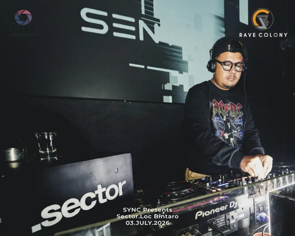 DJ wearing glasses and a black band shirt adjusts the mixer at a club booth with a large 'Sector' sign in the background.