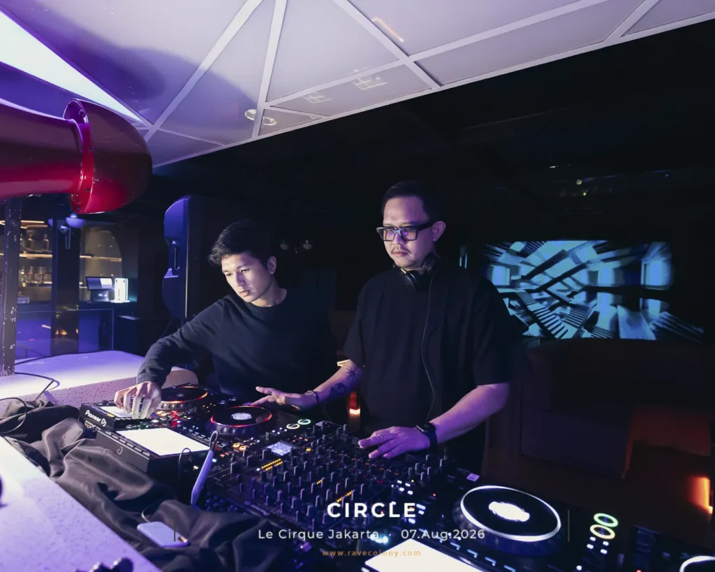 Two male DJs in black shirts perform at a nightclub, mixing on Pioneer gear under purple lighting; text on screen reads 'CIRCLE Le Cirque Jakarta 07 Aug 2026'.